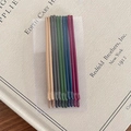 Colorful matte metal bobby pin set in cream, grey, navy, and green on display card - Dark Colors - Flat Style