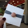 Elastic hair tie with a matte peach round bead on a premium grey fabric band - Pink