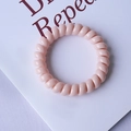 Minimalist spiral phone cord hair tie in macaron pink color with smooth finish - Sakura Pink