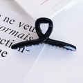 Minimalist glossy black crisscross hair claw clip for women on white background - Black (3)