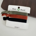 Elastic braided hair ties set in dark green, burnt orange, and black on a white card - Style 11