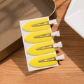 Set of four bright yellow seamless duckbill hair clips on white card for styling - Yellow