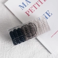 Spiral telephone cord hair ties in black, amber, and clear colors in a TPU storage box - Black Gradient
