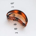Minimalist amber tortoise shell hair claw clip with a glossy translucent finish - Amber