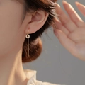 Elegant gold drop earrings featuring a sparkling zircon circle and long delicate tassel chain - Gold