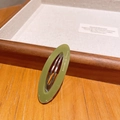 Grass green oval acetate hair clip with white lettering on a wooden jewelry tray - Mustard Green