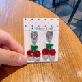 Child resin clip-on earrings with cute cherry pendant and glitter heart detail - Green Leaf Cherry