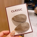 Paar champagne goud glitter haarklemmen in druppelvorm op witte kartonnen kaart - Goud