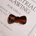 Elegant tortoiseshell acetate bow hair clip with Handmade France engraving on a book - Coffee Texture