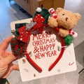 Detail of Christmas headband featuring plush bear, festive bow, and candy cane on display card - 2-Slap Bear Headband
