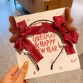 Detailed view of plush reindeer antlers and red ruffle bow on a Christmas headband - 10-Antler Headband