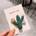 Handmade green cactus hair clip with pink knit flowers and sequin star details - Cactus