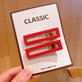 Pair of minimalist red rectangular acrylic hair clips on classic white display card - Square Red Hair Clips