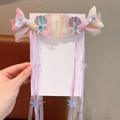 Detail of mermaid tail hair clips with shimmering sequins and hanging pastel ribbons - Pink Purple Starfish Style