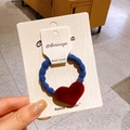 Dark red velvet heart hair tie with deep blue spiral rope on a white display card - Blue Ring Red Heart