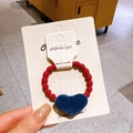 Red elastic velvet scrunchie with a blue heart-shaped velvet charm on display card - Red Ring Blue Heart