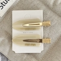 Eleganti fermagli per capelli in acetato beige con texture marmorizzata e base dorata - Bianco Crema