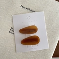 Pair of amber resin teardrop hair clips with France Handmade text on white card - Brown