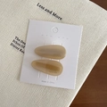 Pair of khaki teardrop hair clips with acetate finish on white display card - Apricot