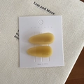 Amber yellow waterdrop hair clips in translucent resin displayed on white card - Yellow