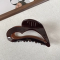 Glossy chocolate brown heart hair claw clip in a hollow design with gold lettering - Tea Brown