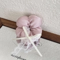 Pink satin scrunchie with white lace bow and long ribbons on a decorative mirror - Pink