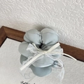 Pale green satin scrunchie with white lace bow on mirror tray for a retro look - Green