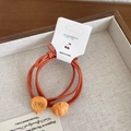 Elastic orange hair tie set featuring pumpkin-shaped beads and autumn pumpkin slices - Brick Red