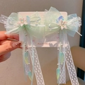 Detailed macro view of light green lace bow hair clips with flowers and long tassels - Gardenia Lace Ribbon