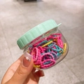 Jar of colorful elastic hair bands for girls in pastel macaron shades and mint green lid - Pink Series