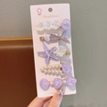 Detalle de set de 5 horquillas marinas con conchas púrpuras y diseños de cola de pez - Set de 5 Púrpura / Morado