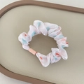 Pink satin hair scrunchie with colorful heart pattern on elegant cream leather tray - Pink Hair Ring