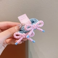 Pair of pink bow hair ties with heart patterns on blue elastic bands for girls - Blue