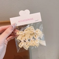 Set of pale yellow lace bow hair clips with white pearls in clear hanging package - Yellow