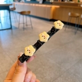 Barrette à cheveux pour enfants avec trois étoiles jaunes souriantes sur socle noir - Biscuit Étoile