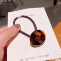Retro hair tie featuring a polished tortoiseshell resin charm and a brown elastic cord - Dark Tortoiseshell