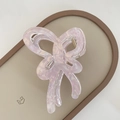 Macro shot of jelly purple butterfly hair claw clip with elegant marble texture detail - Pink