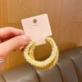Set of two soft plush yellow knitted hair scrunchies on a cardboard display card - Yellow Series