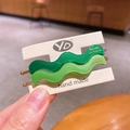Set of two wavy matte acetate hair clips in dark and light green with gold label - Green Series