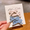 Set of four cute plush bow hair clips in soft pink and blue on display card - White Blue