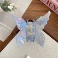 Pince à cheveux papillon bleue élégante avec texture marbrée nacrée et ressort doré - Bleu