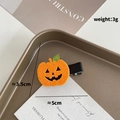 Handmade orange felt pumpkin hair clip for Halloween with Jack-o-lantern face and green leaf - Orange Felt Jack-o'-lantern Smile (968-31)