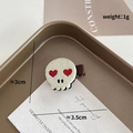 Handmade Halloween hair clip featuring a white felt skull with red sequin heart eyes - Creamy White Skull Red Heart Eyes (968-34)