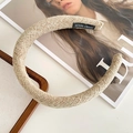 Beige woven tweed headband with thick padding and handmade label on a white surface - Beige