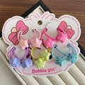 Set di elastici per capelli bimba con stelle a pois colorati su cartoncino - Stile Stella