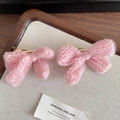 A pair of pink knitted bow hair clips with golden alligator clips for hair styling - Pink