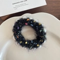 Cute black plush scrunchie with colorful accents and pearl beads in a ceramic dish - Black