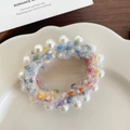 Grey plush hair scrunchie with colorful dots and white pearls on ceramic plate - White