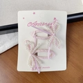 Set of two pink ballet-style bow hair clips with pearls on a display card - Pink