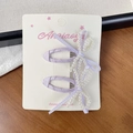 Two-piece lavender ballet style hair clips with handmade pearl bows on display card - Purple